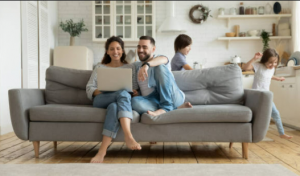 Couple sitting on a lounge with a laptop